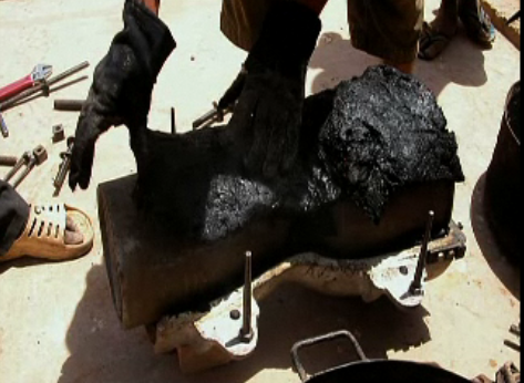 Molds of plastic trash being made into a drum